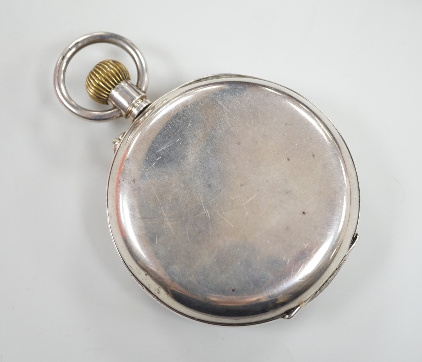 A tortoiseshell mounted travelling watch case, containing a Swiss white metal pocket watch, case diameter 67mm, outer case 11.5cm.
